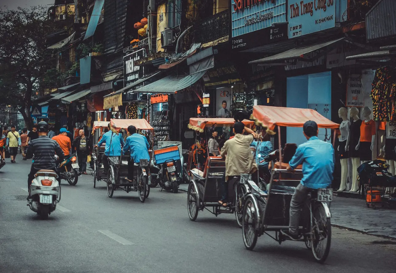 Bustling streets of Ho Chi Minh with scooters and cycle rickshaws