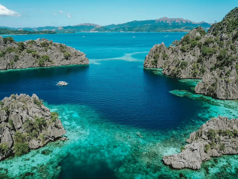 A view of beautiful lagoons wth clear waters within rocky limestone formations in Coron Island 